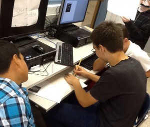 4 boys using 1 computer to do different activities